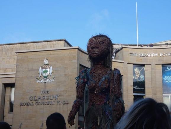 33 foot tall Puppet Storm heading through the streets of Glasgow